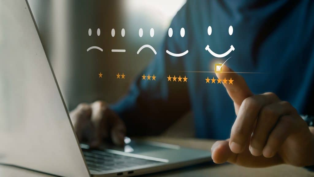 Person at a laptop checking a box for a 5-star review.