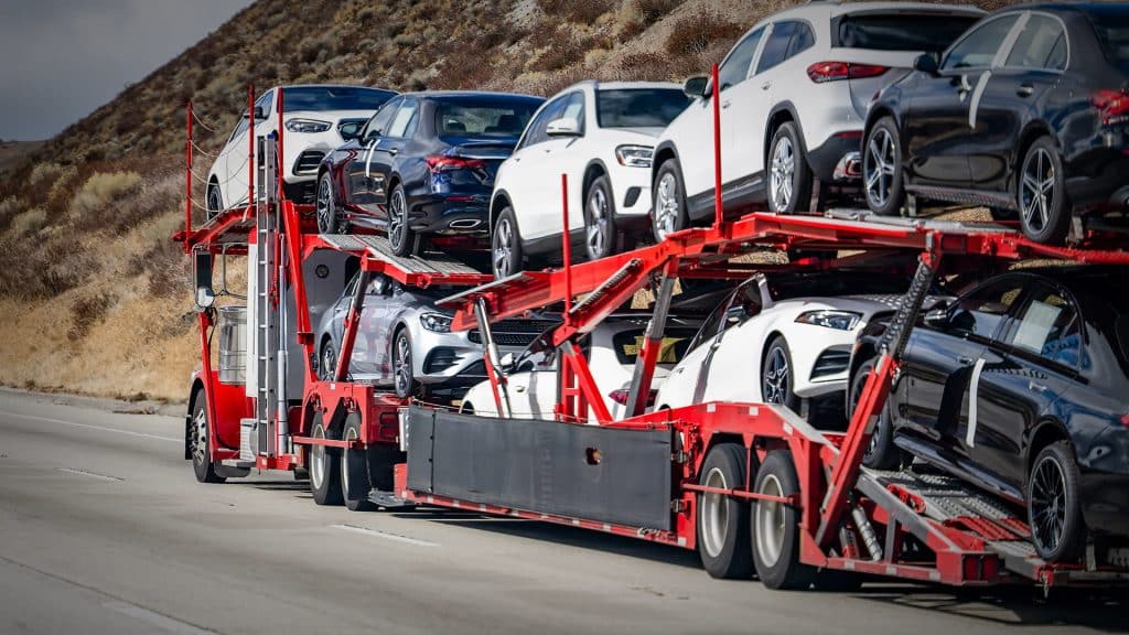 Cost effective open car carrier transporting vehicles
