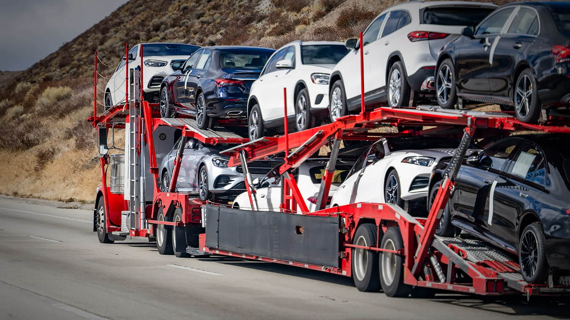 Cost effective open car carrier transporting vehicles