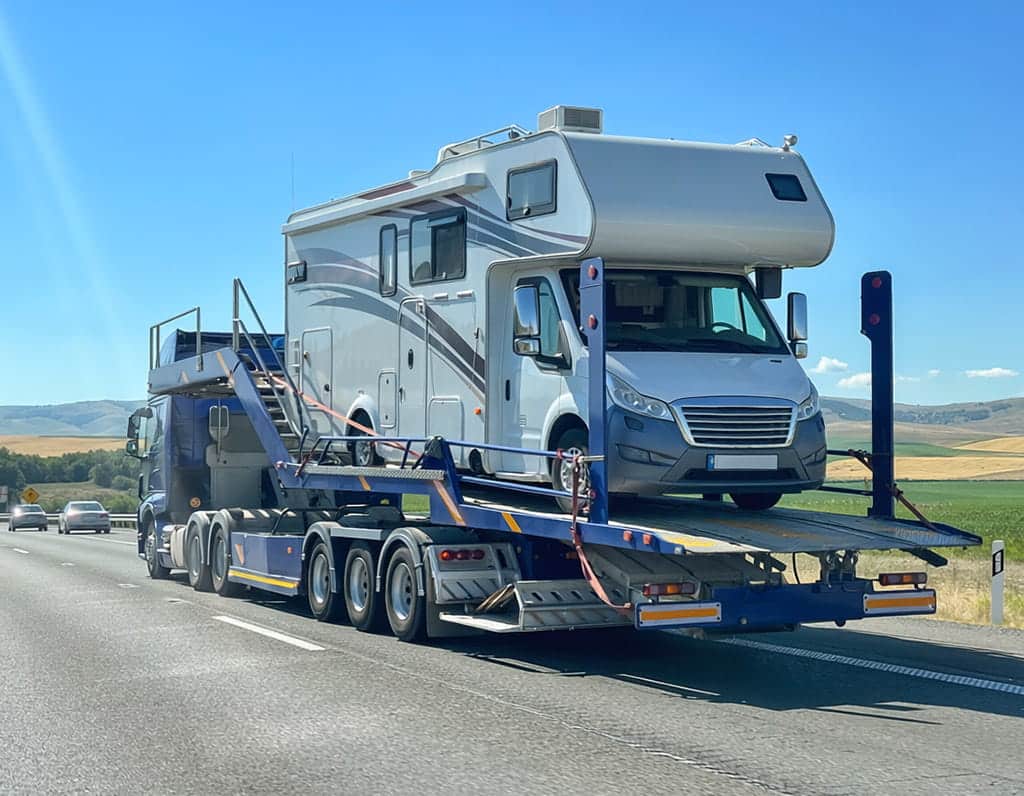 Open carrier transporting an RV